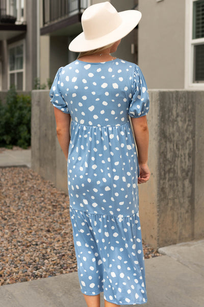 Back view of a short sleeve blue dress with white spots