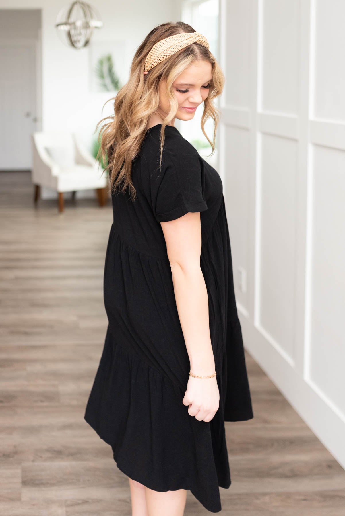 Side view of a black tiered dress