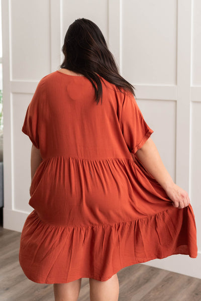 Back view of a plus size cinnamon tiered dress