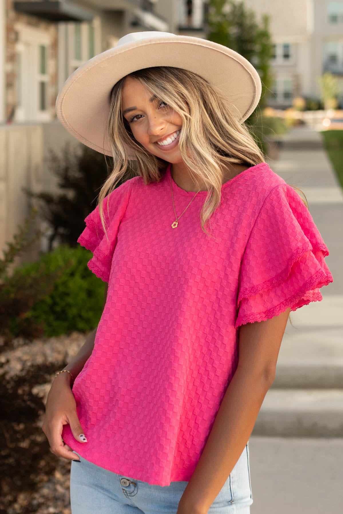 Short sleeve pink top with a ruffle style sleeve