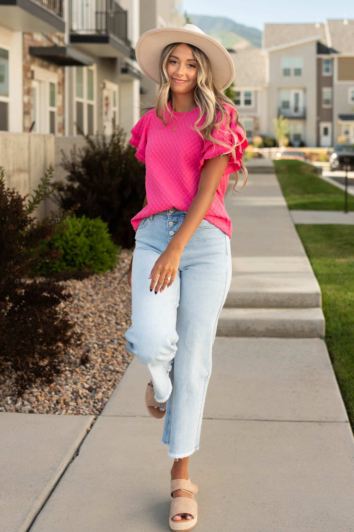 Pink top with light wide leg jeans that are sold separately