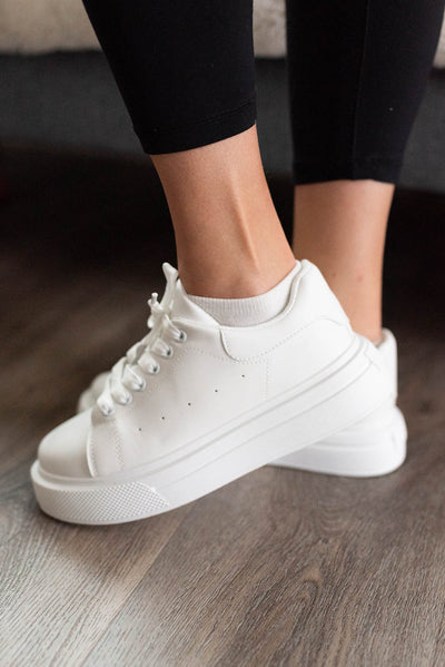 Side view of the the white lace up sneakers