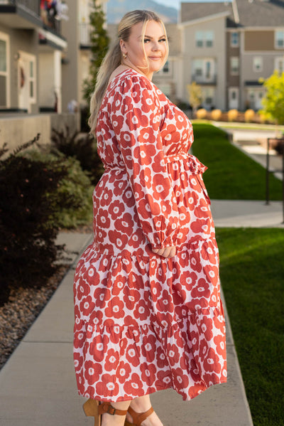 Side view of a plus size brick floral dress