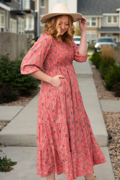 Side view of a red floral dress with pockets