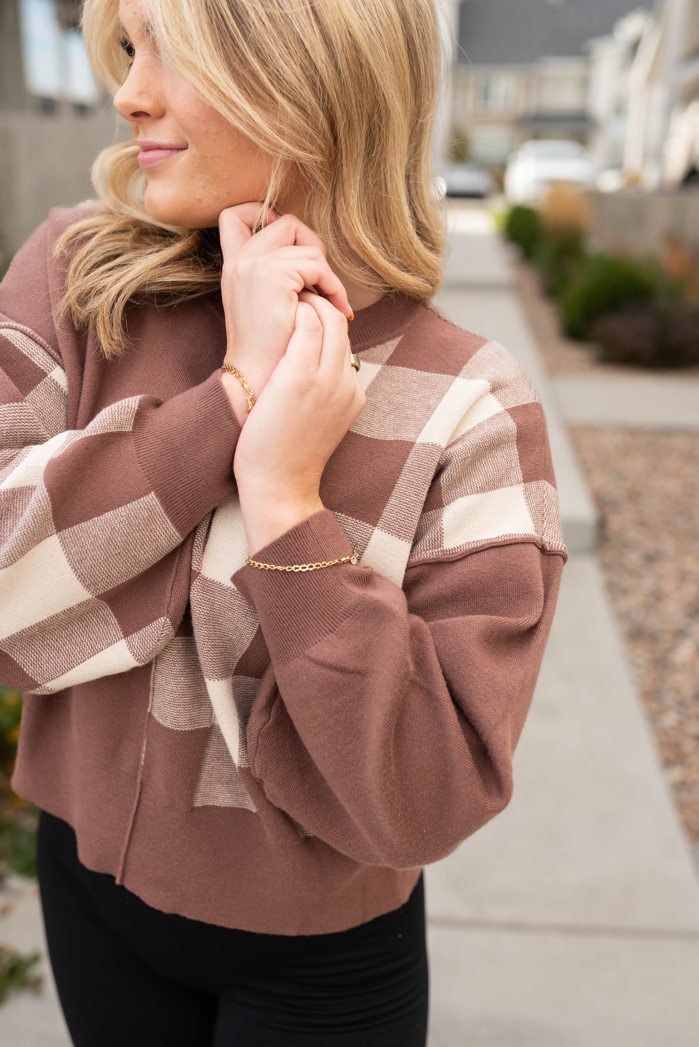 Close up of the checkered pattern on the long sleeve mocha checkered sweater