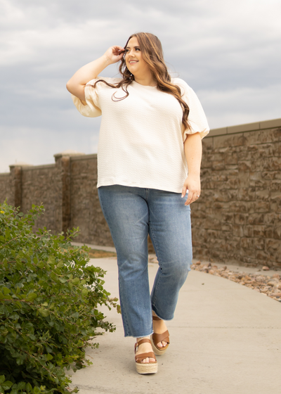 Front view of plus size cream textured top