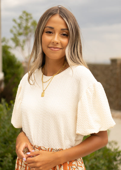 Cream textured top with short puff sleeves