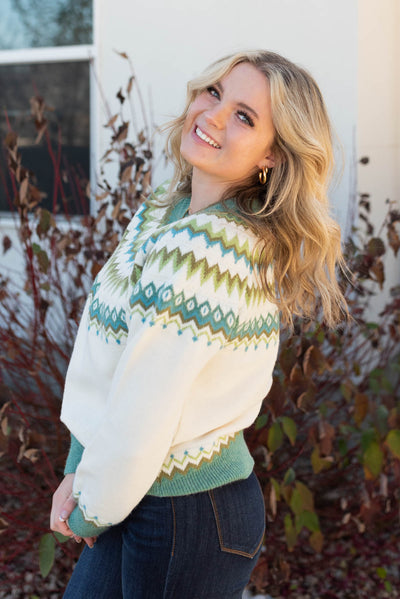 Side view of the cream pattern sweater