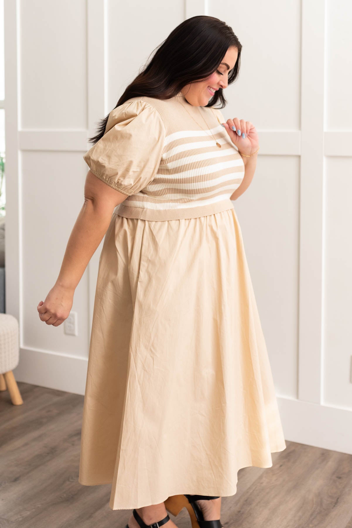 Side view of a sand stripe knit dress in plus size