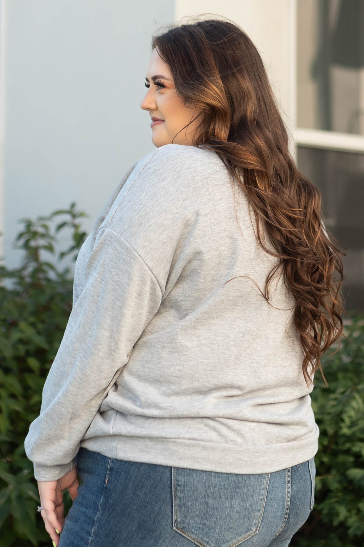 Side view of a plus size heather grey pullover