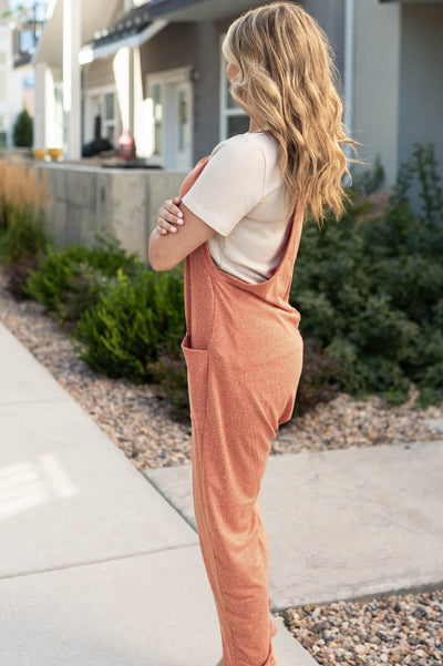 Side view of a rust jumpsuit