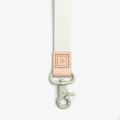 Cream thread wallet lanyard with pink tab.