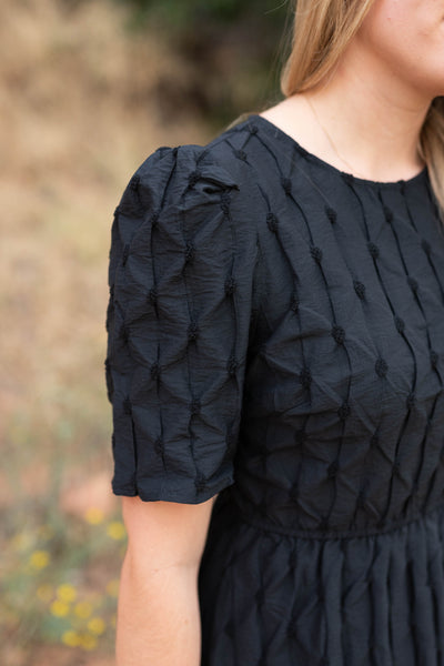 Sleeve view of a black dress
