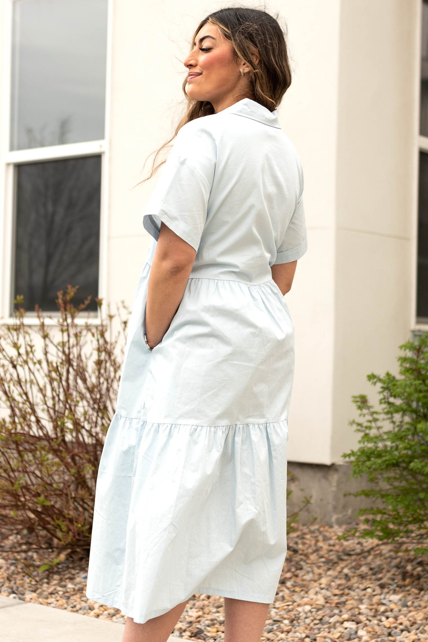 Side view of a button up blue collar dress