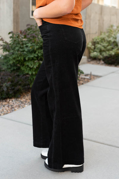 Side view of black corduroy pants