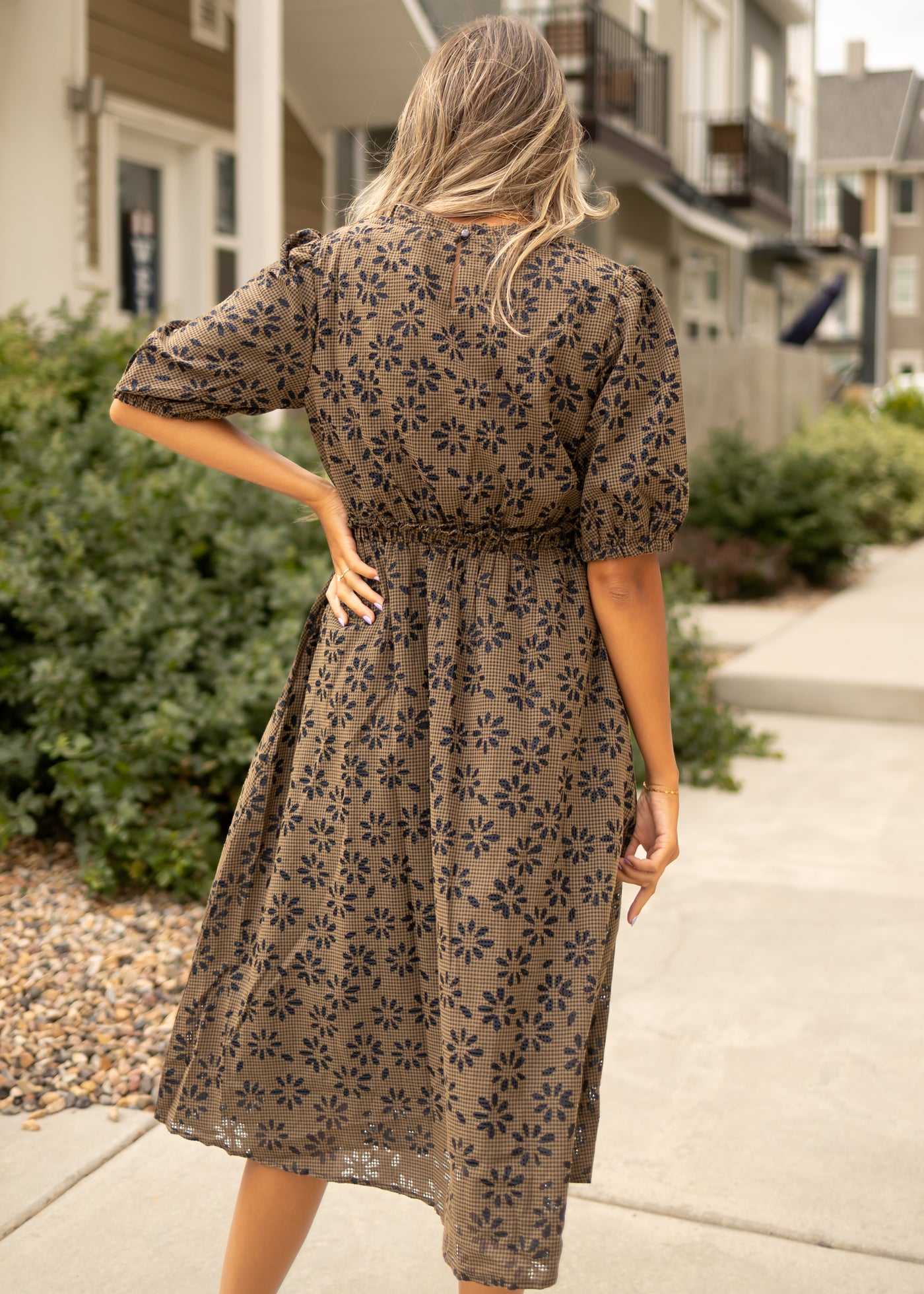 Back view of a mocha gingham dress with navy floral print
