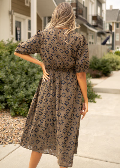 Back view of a mocha gingham dress with navy floral print