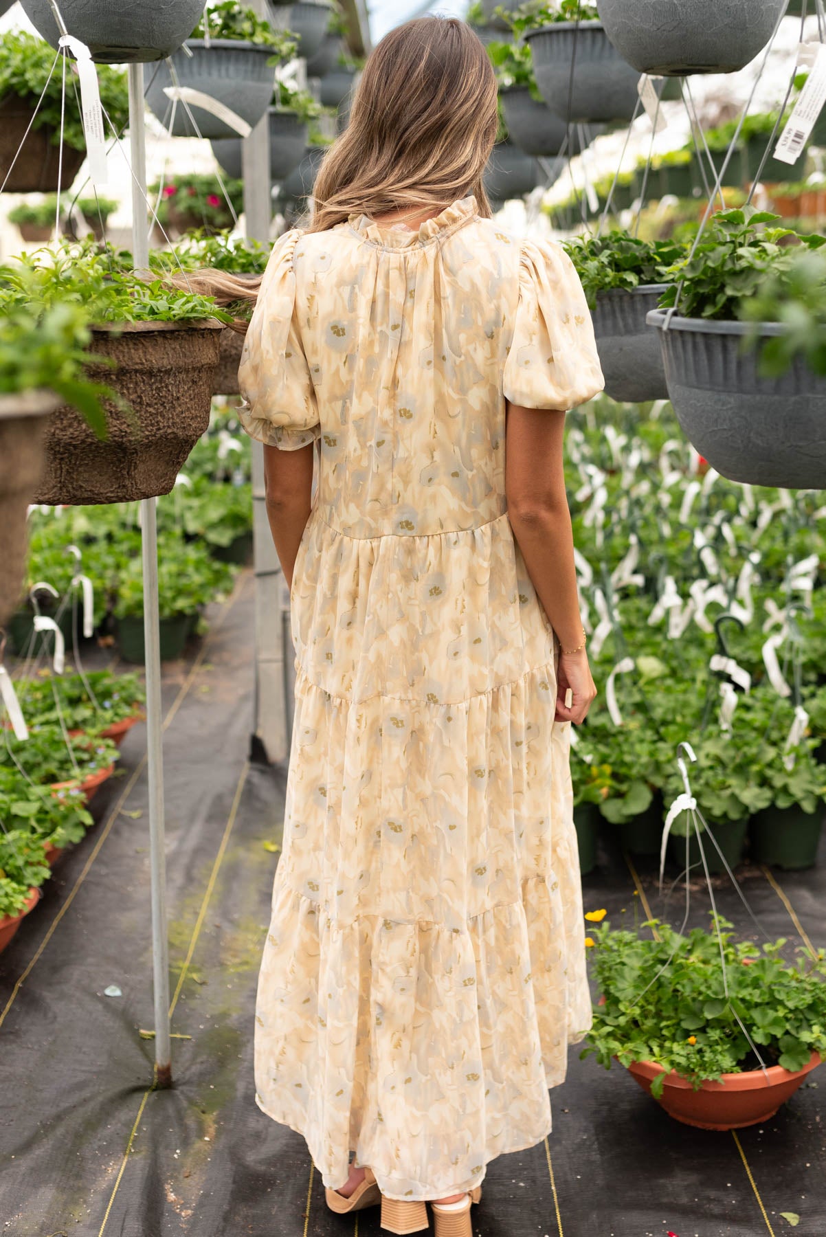 Back view of the tan pattern tiered dress 
