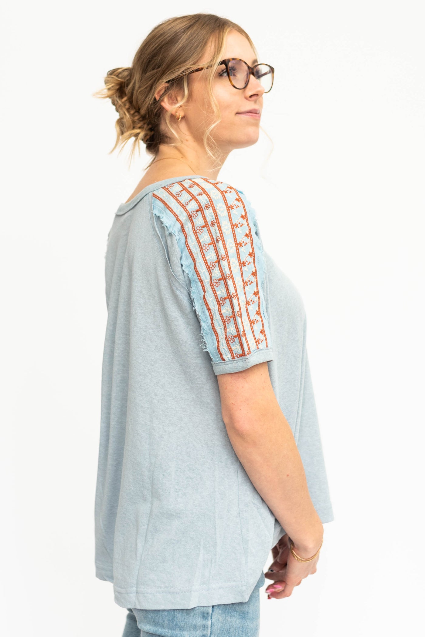 Side view of short sleeve chambray top