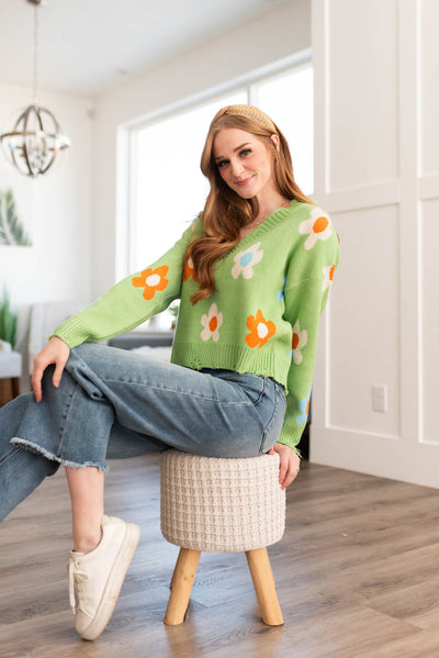 Green floral sweater with large daisies