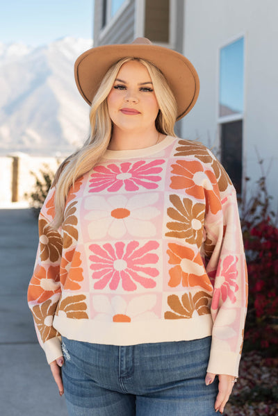 Front view of the plus size cream floral sweater