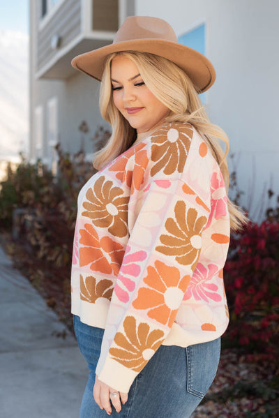 Side view of the plus size cream floral sweater