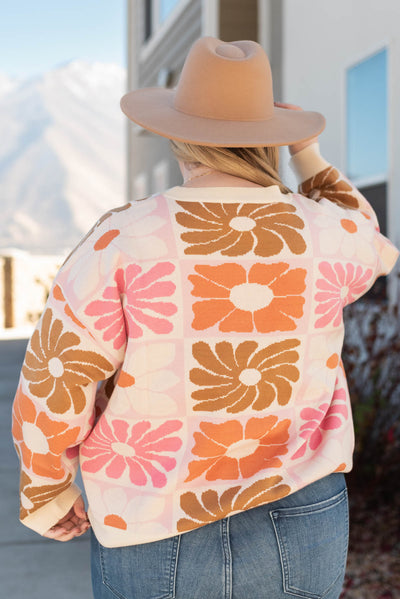 Back view of the plus size cream floral sweater