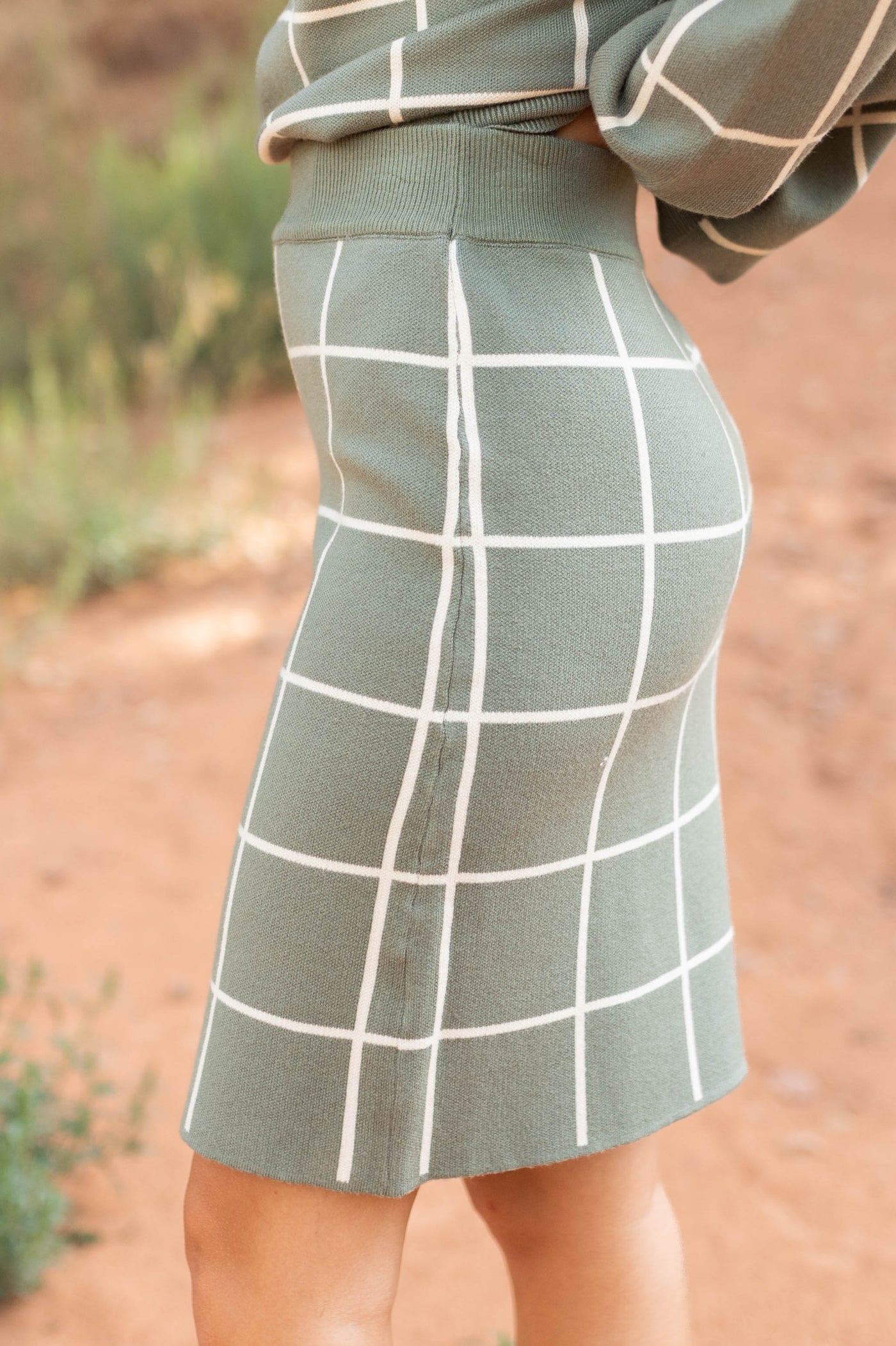 Side view of a olive plaid skirt