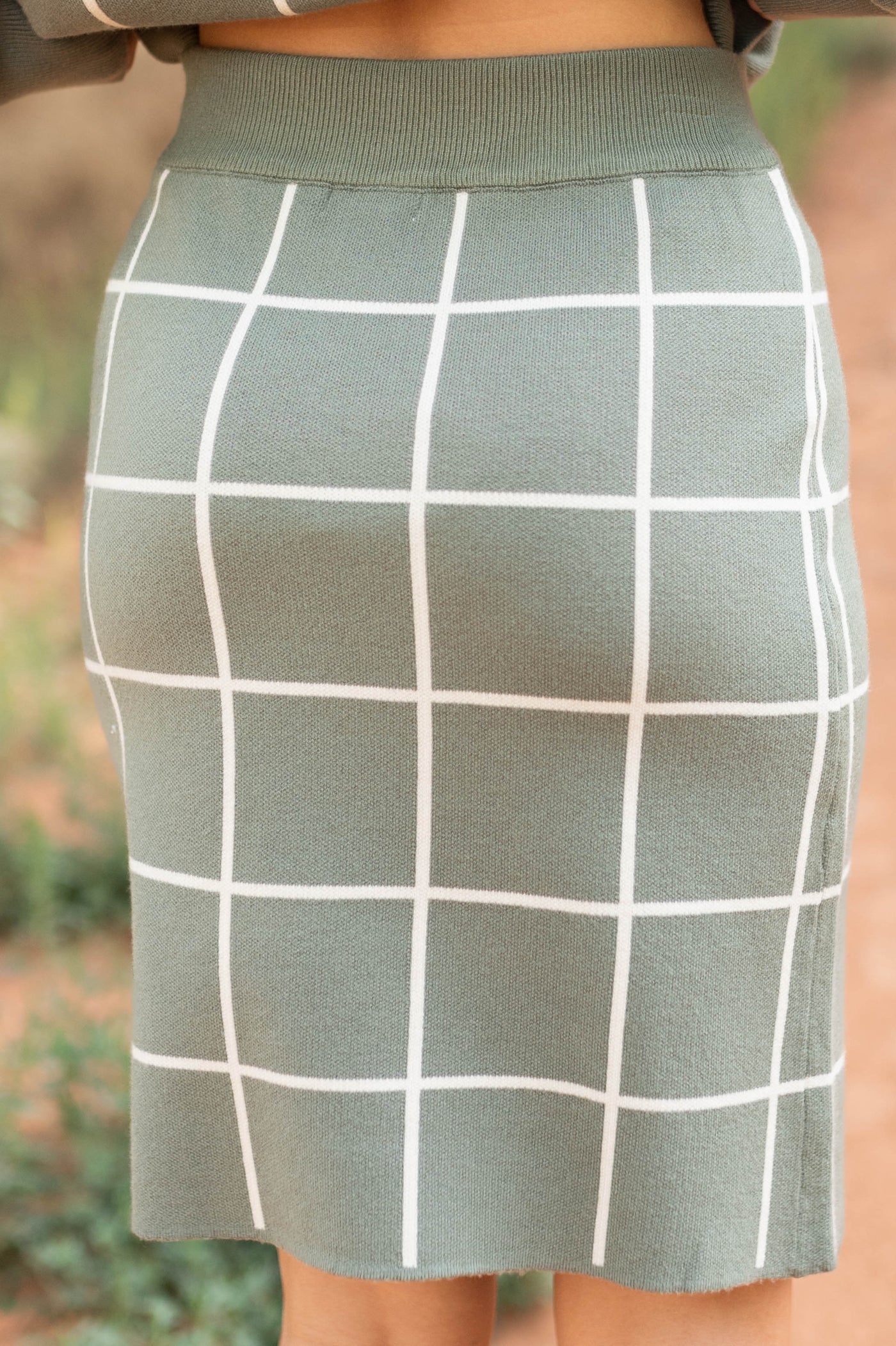 Back view of a olive plaid skirt