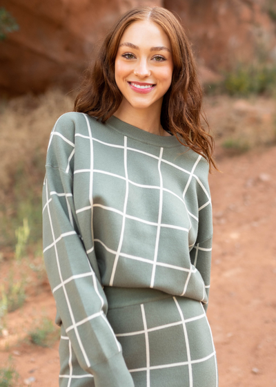 Long sleeve olive plaid sweater with a drop sleeve