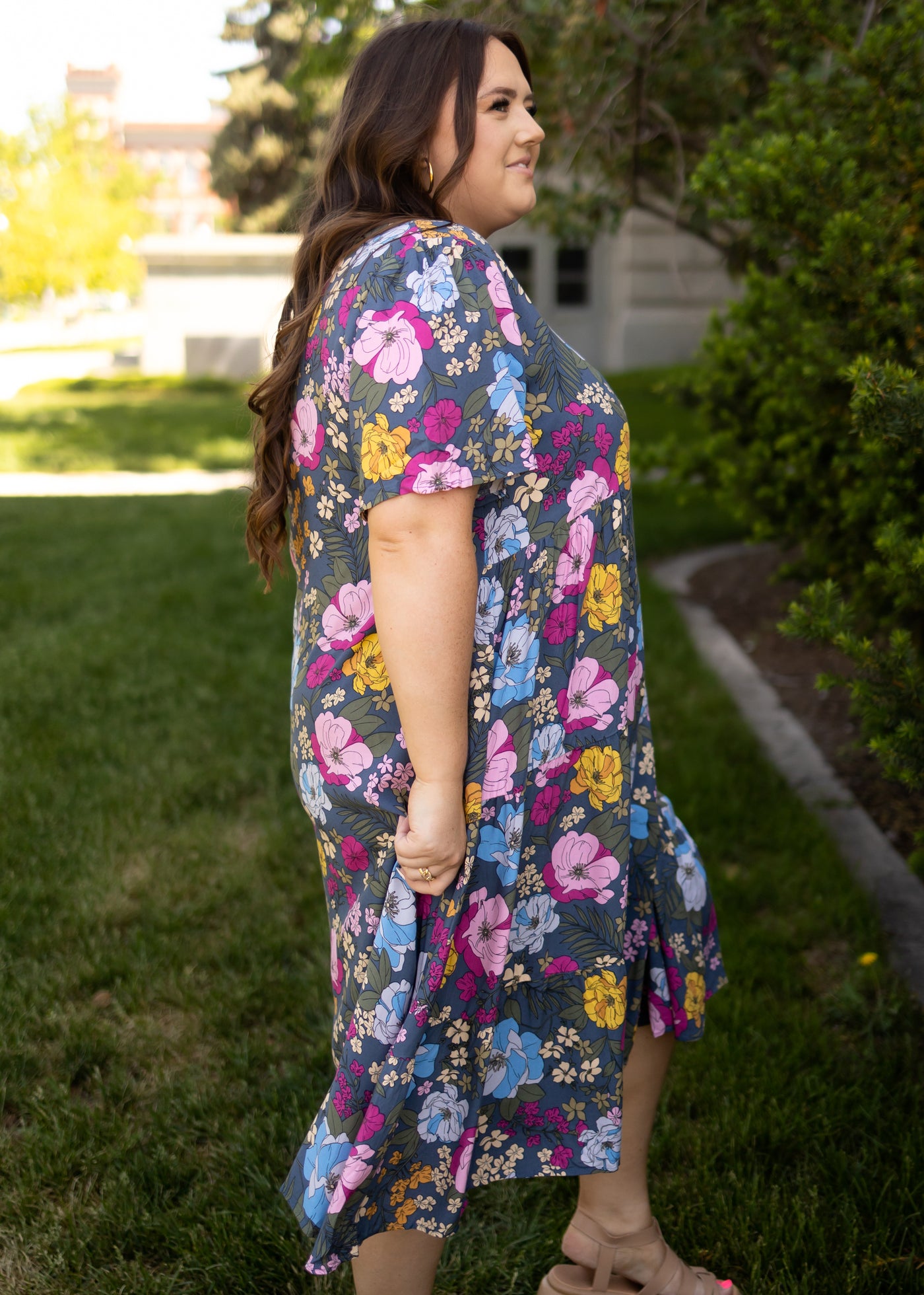 Side view of a plus size navy floral dress