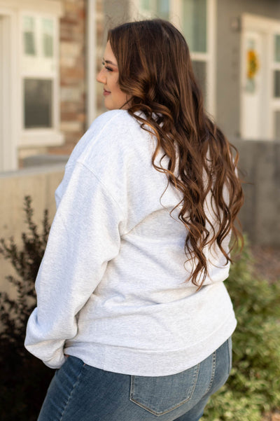 Side view of a plus size boohaw grey sweatshirt