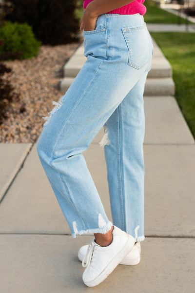 Side view of light high rise distressed mom jeans