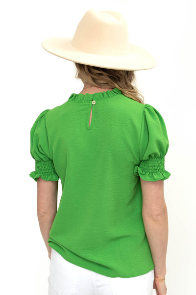 Back button on a kelly green top