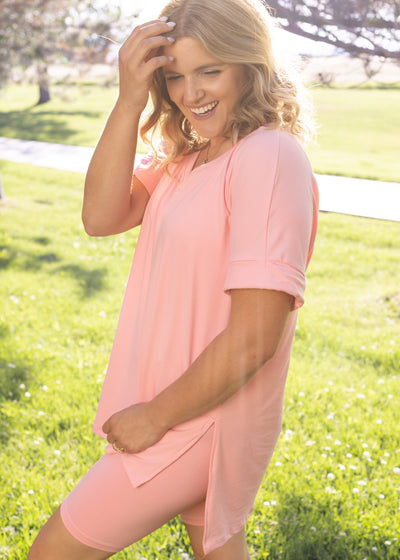 Side view of a short sleeve pink set with biker shorts