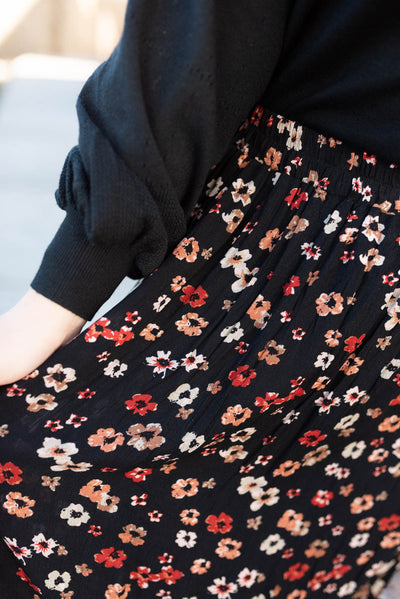 Close up of the pattern on a black floral skirt