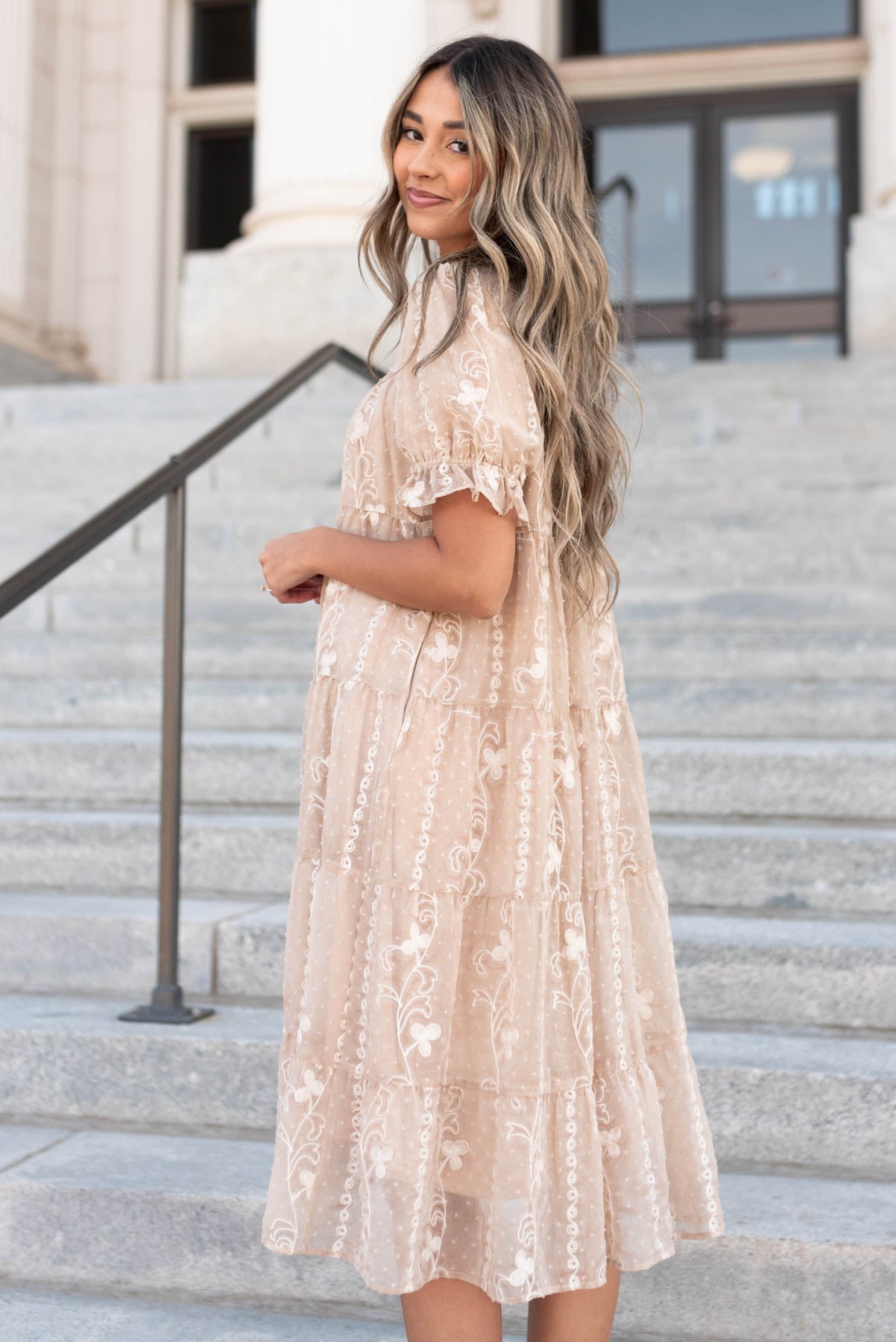 Side view of the beige embroidered dress