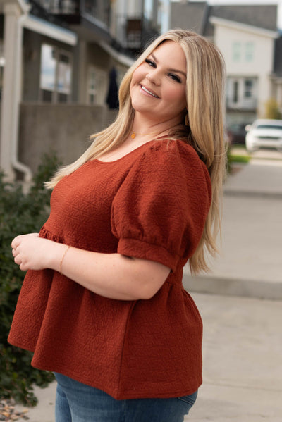 Side view of a plus size auburn tiered shirt