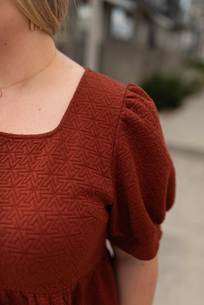 Fabric design on the plus size auburn tiered shirt