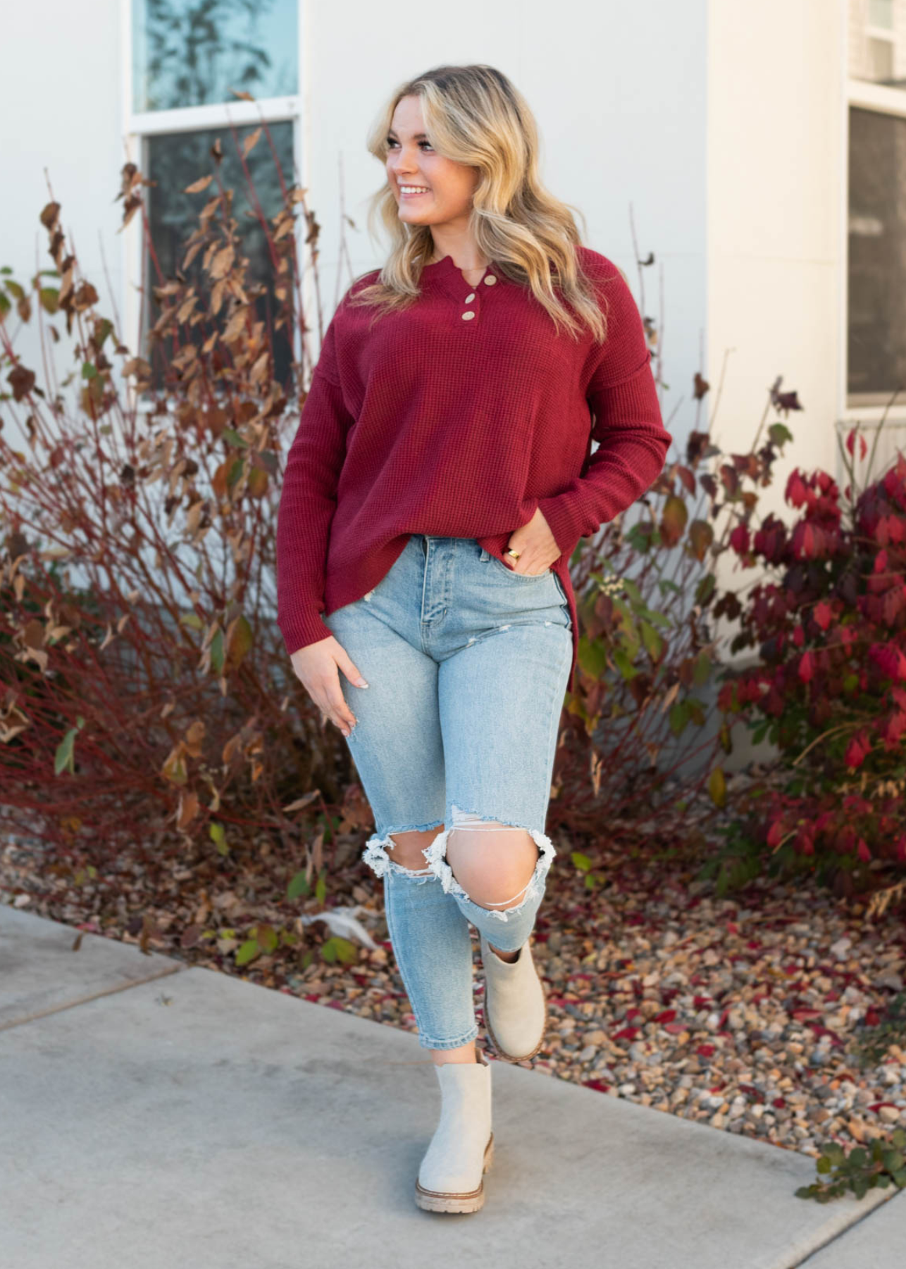 Long sleeve burgundy sweater with buttons at the neck