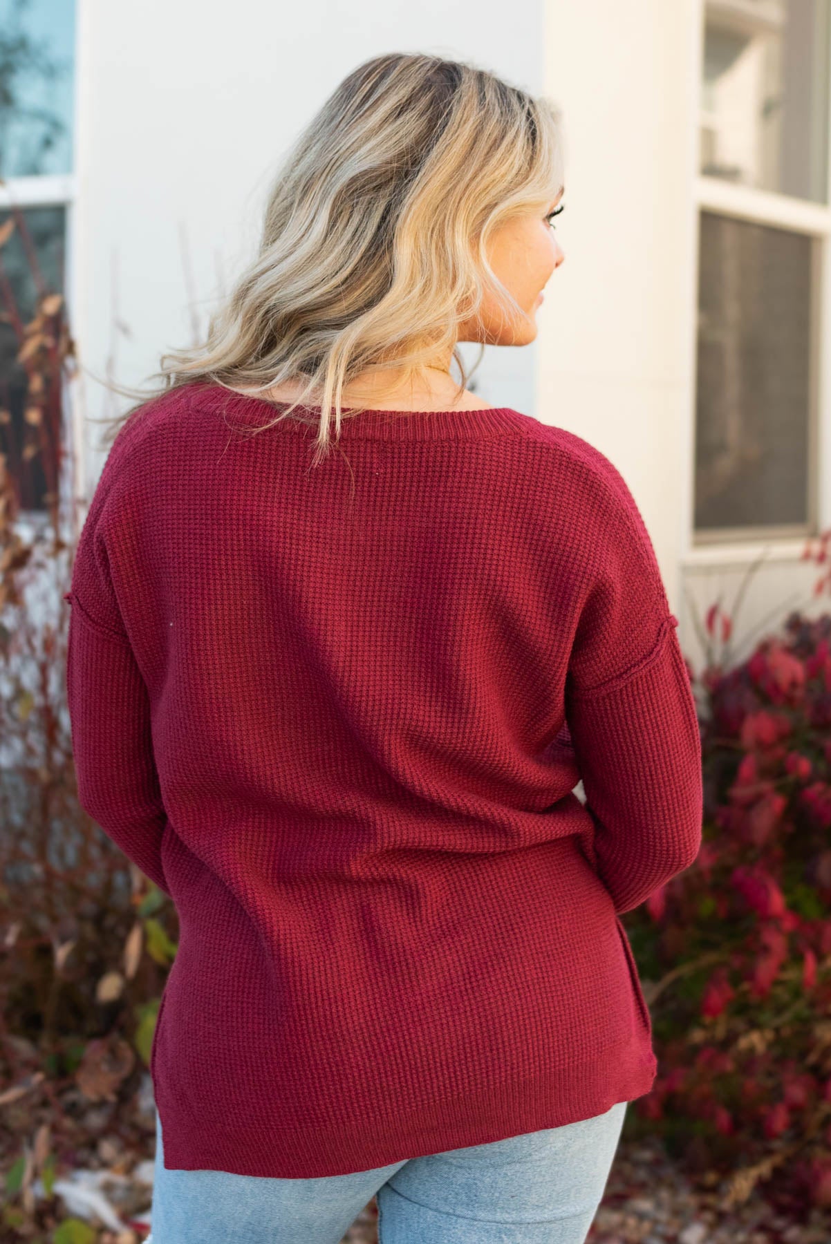 Back view of a long sleeve burgundy sweater