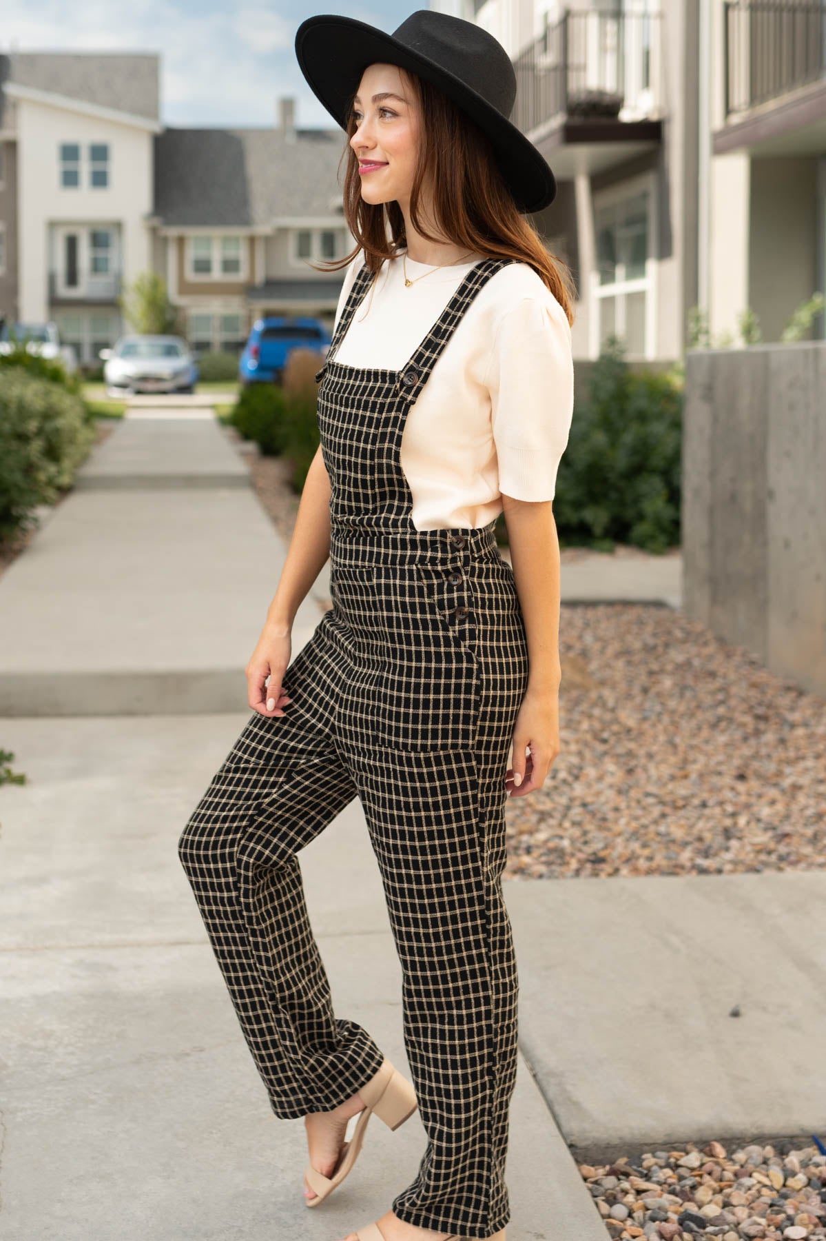 Side view of black plaid overalls