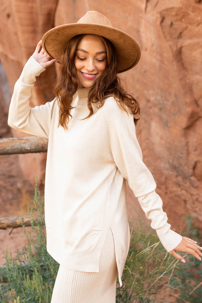 Side view of a oatmeal sweater