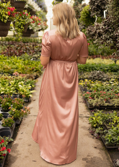 Back view of a long short sleeve blush dress