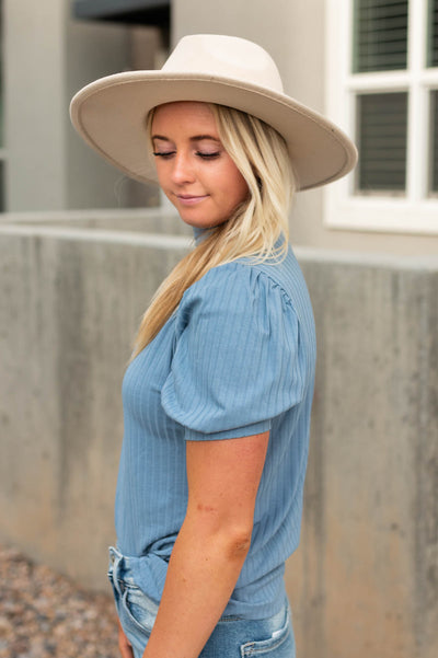 Side view of a blue ribbed top
