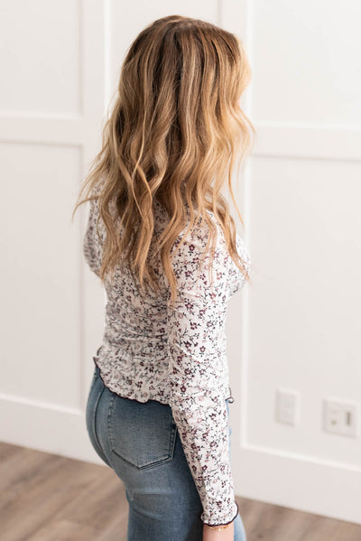 Side view of the burgundy flower print long sleeve top