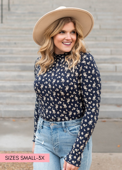 Close up of a navy flower print long sleeve top