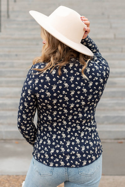 Back view of a navy flower print long sleeve top