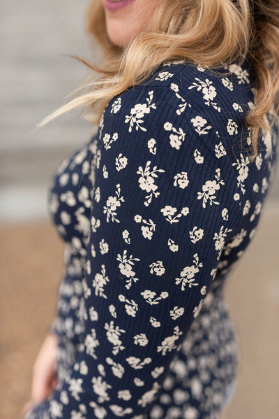Close up of the fabric of the navy flower print long sleeve top