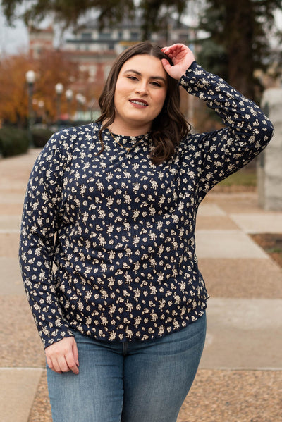 Front view of a plus size navy flower print long sleeve top